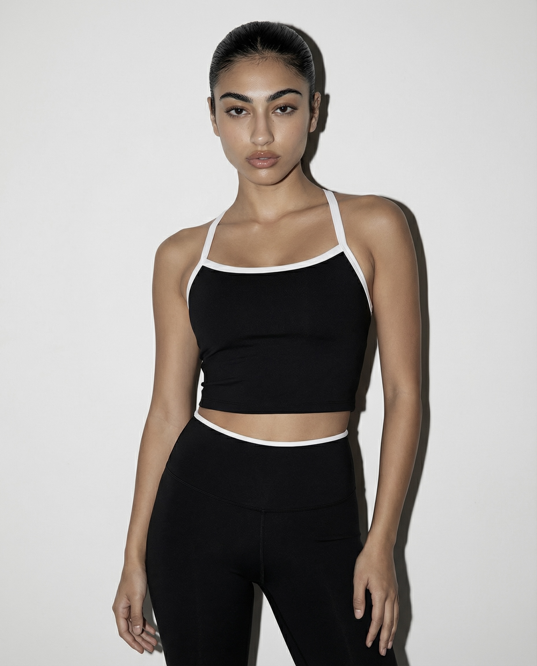 Rhythm activewear model in black crop top and leggings